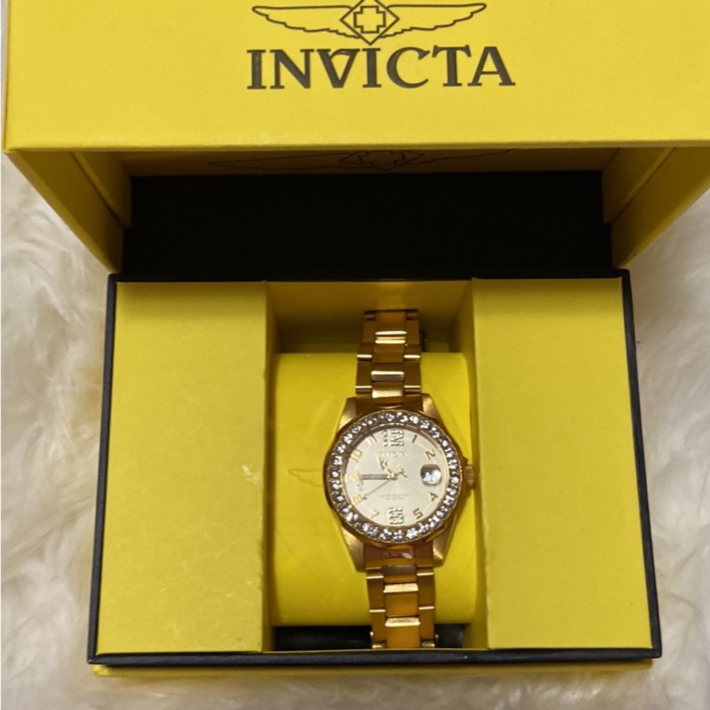 Invicta watch brand new hardly used. Gold band with cubic zirconia rhinestones.